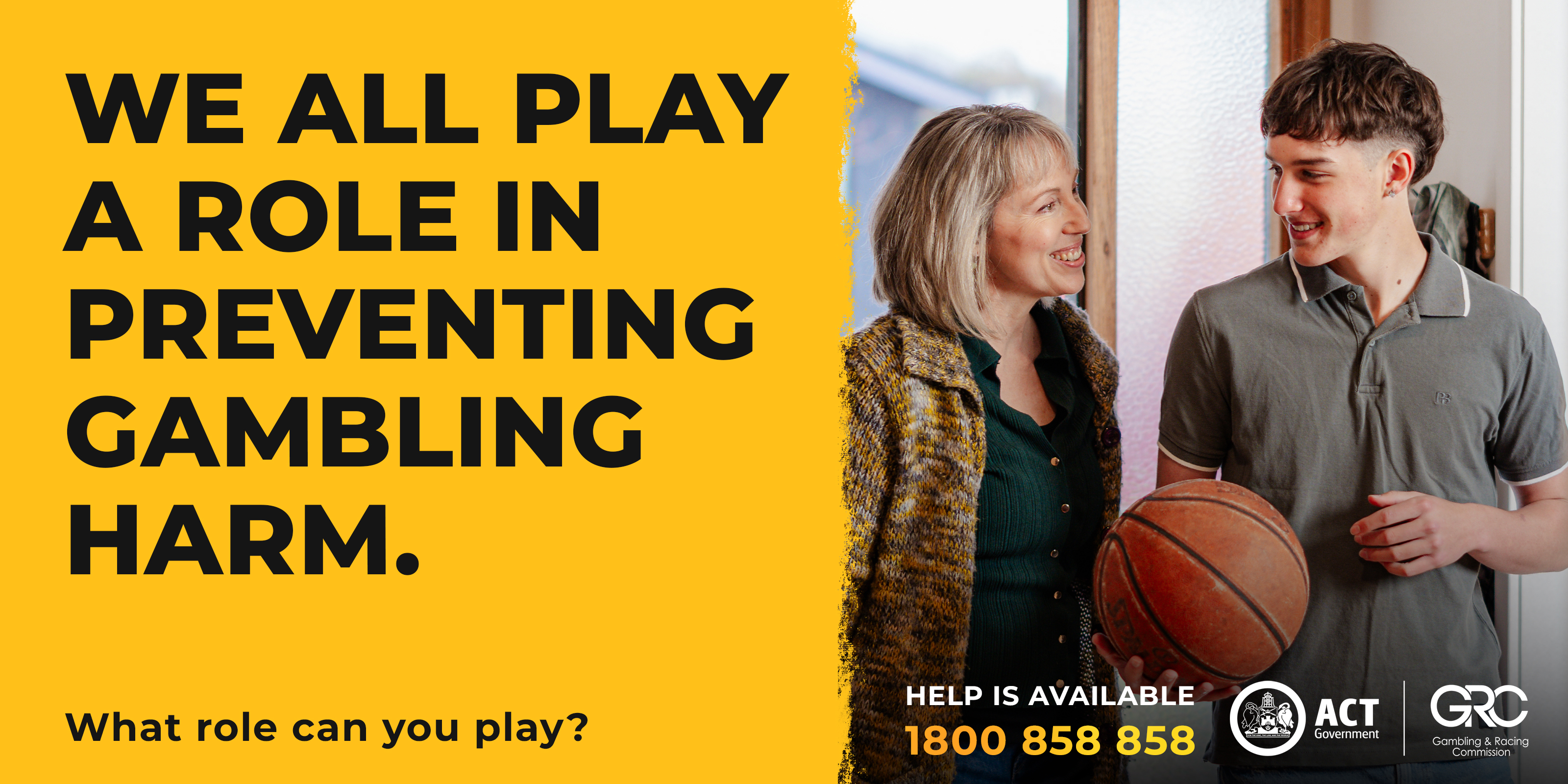Mother and son smiling at each other over basketball